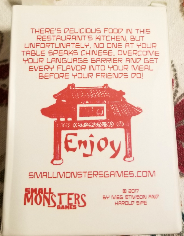 Back of the deck box for Takeout, showing an arch with the word "Enjoy" and the description, "There's delicious food in this restaurant's kitchen, but unfortuantely, no one at your table speaks Chinese. Overcome your language barrier and get every flavor into your meal before your friends do!"