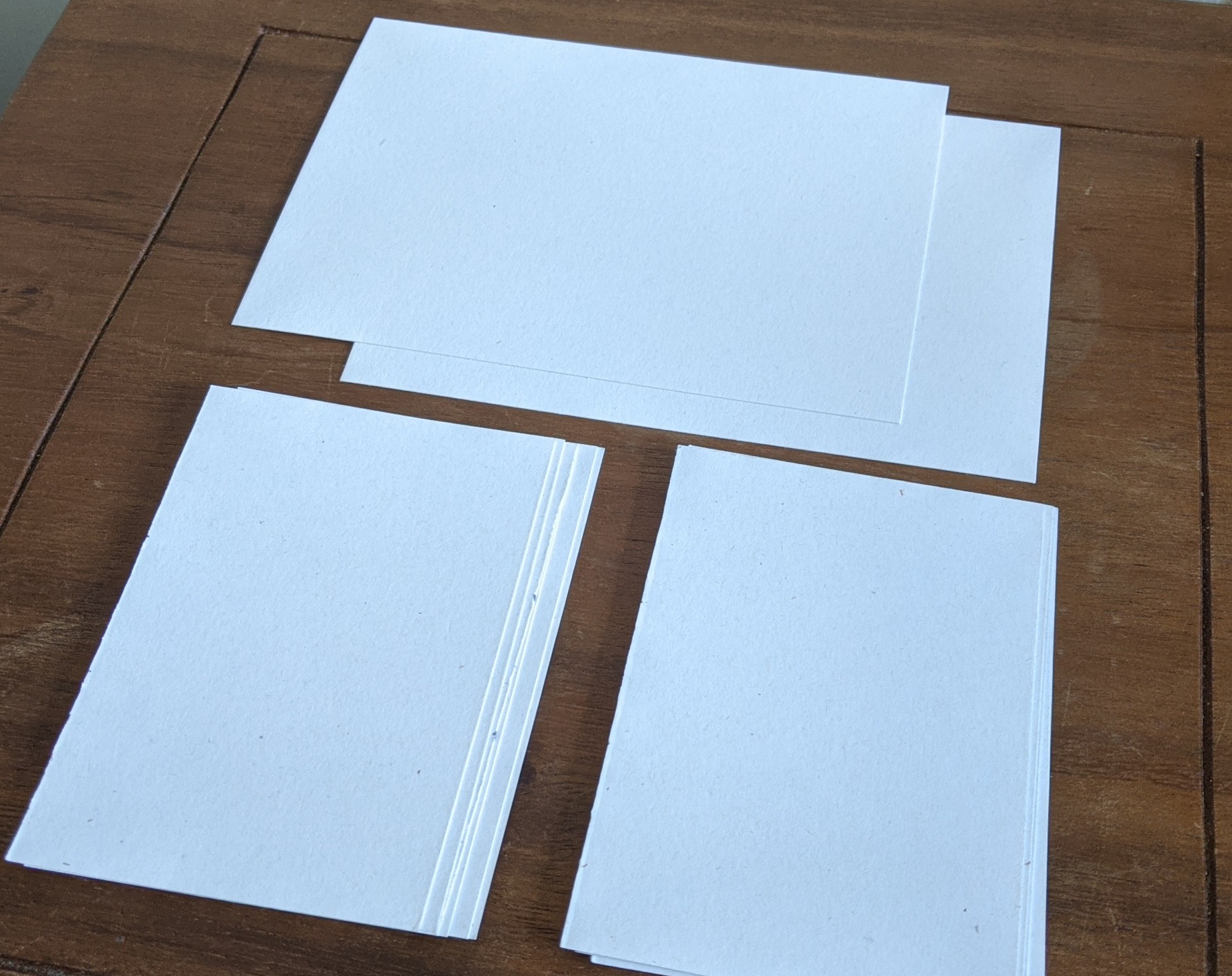 pieces of paper, cut in 2 even halves
