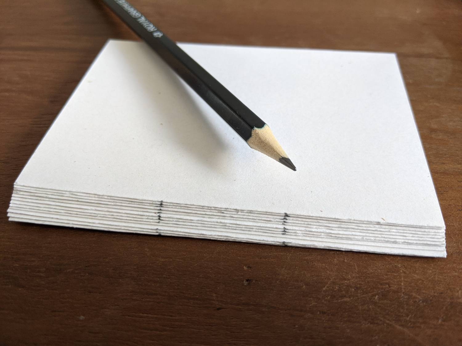 A stack of the paper halved with 2 marks along the edge