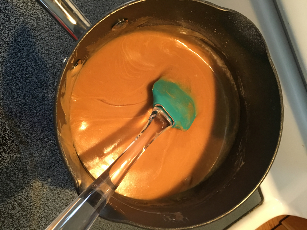 Peanut butter mixed into the hot sugar.