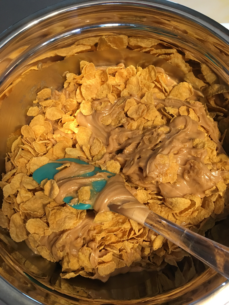 Coat the corn flakes with the peanut butter mixture.