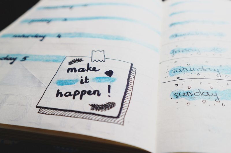 Bullet Journal with a handwritten note to "Make it happen!"