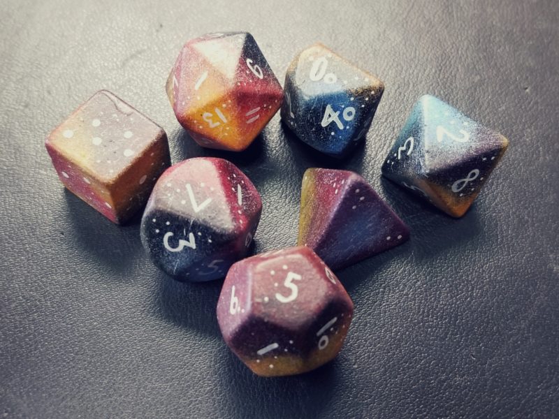 Polyhedral dice painted to look like nebula