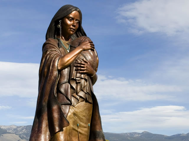 A bronze statue of the Indigenous American explorer, Sacagawea with her infant son, Pomp