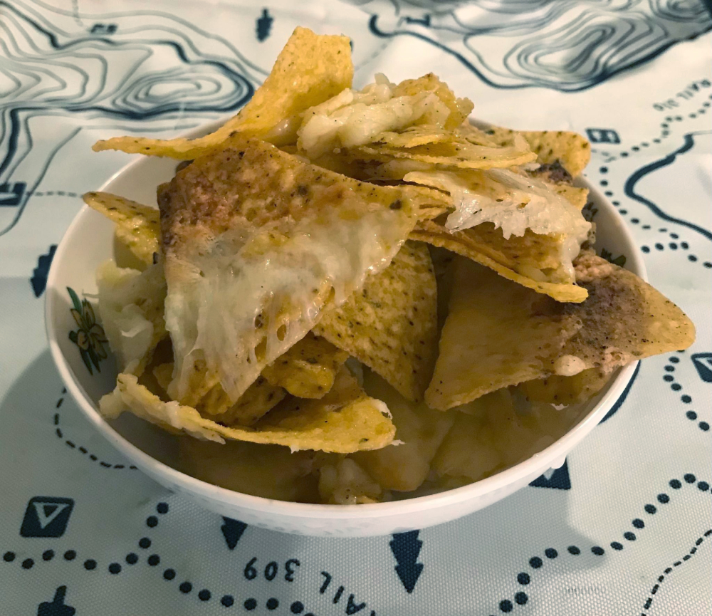 The chips covered in cheese have been moved to a bowl and piled high!