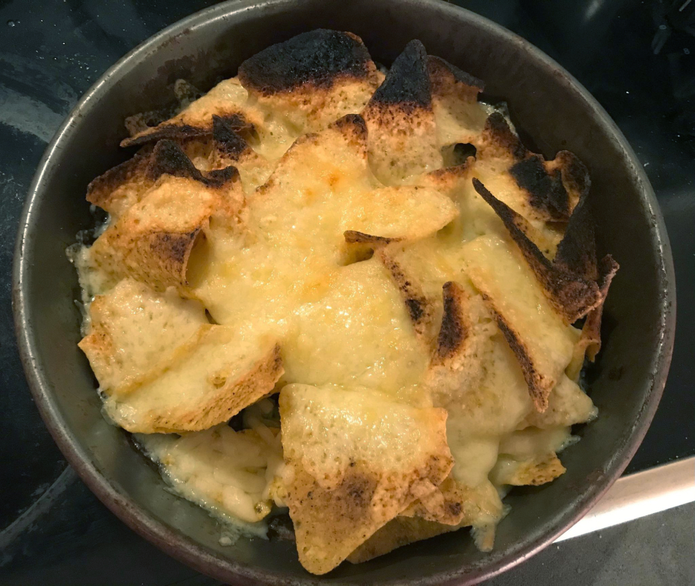 Chips with melted cheese on them in a pot. The cheese got a little toasty. Whoops!