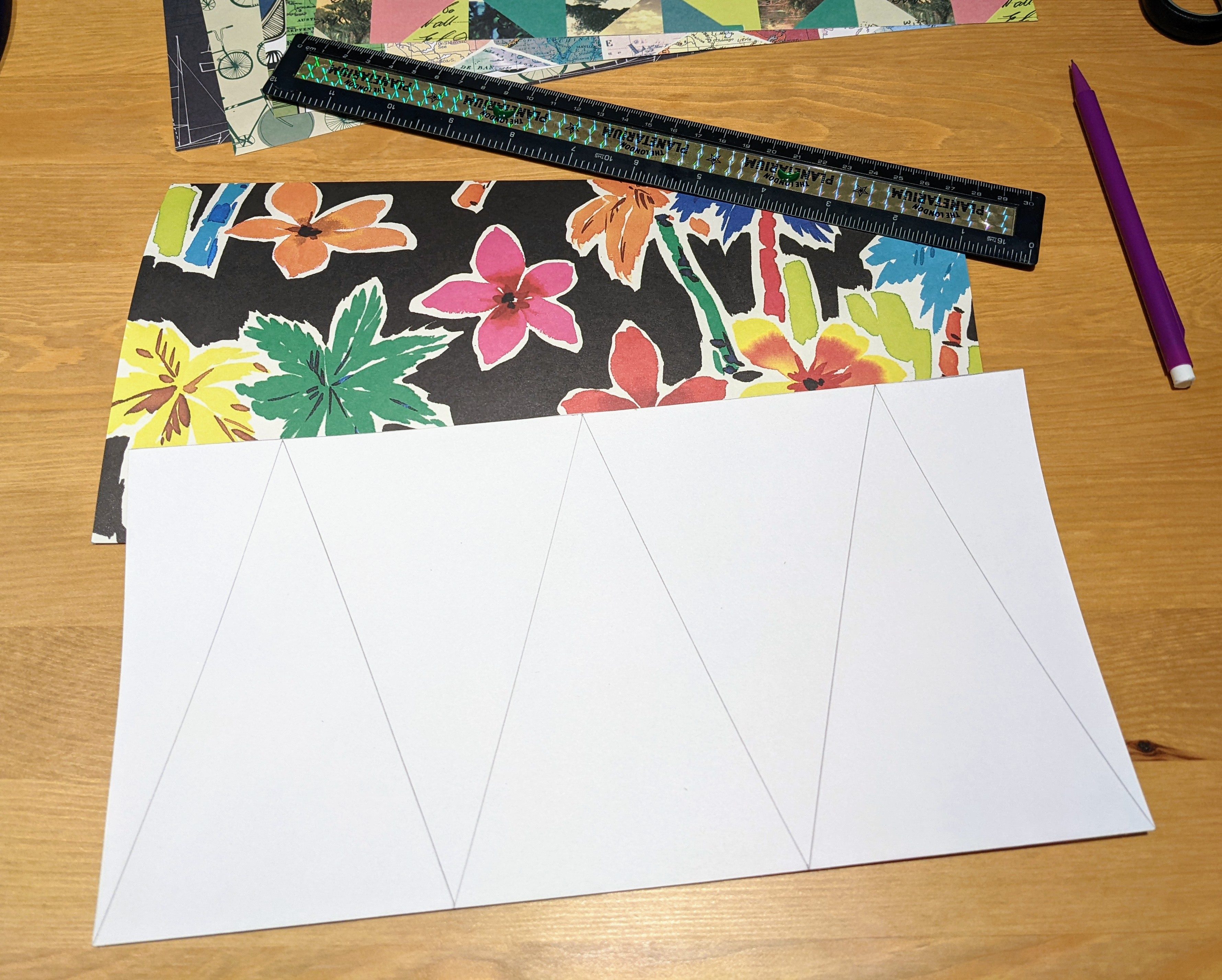 Colorful paper is turned face down and even pennant-triangle shapes are drawn on with a ruler