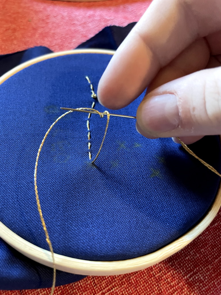 demonstrating a stitch as described in the instructions