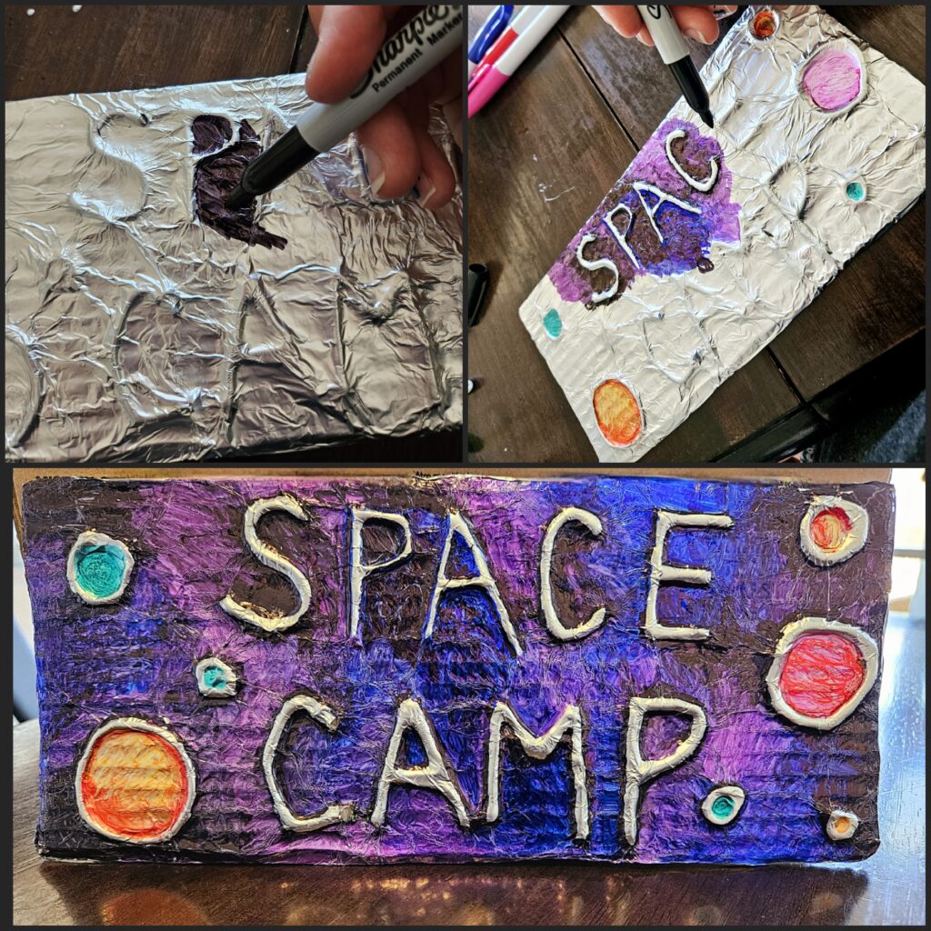 completed project has bright purple-blue background and colorful planets around the words "SPACE CAMP" in raised foil