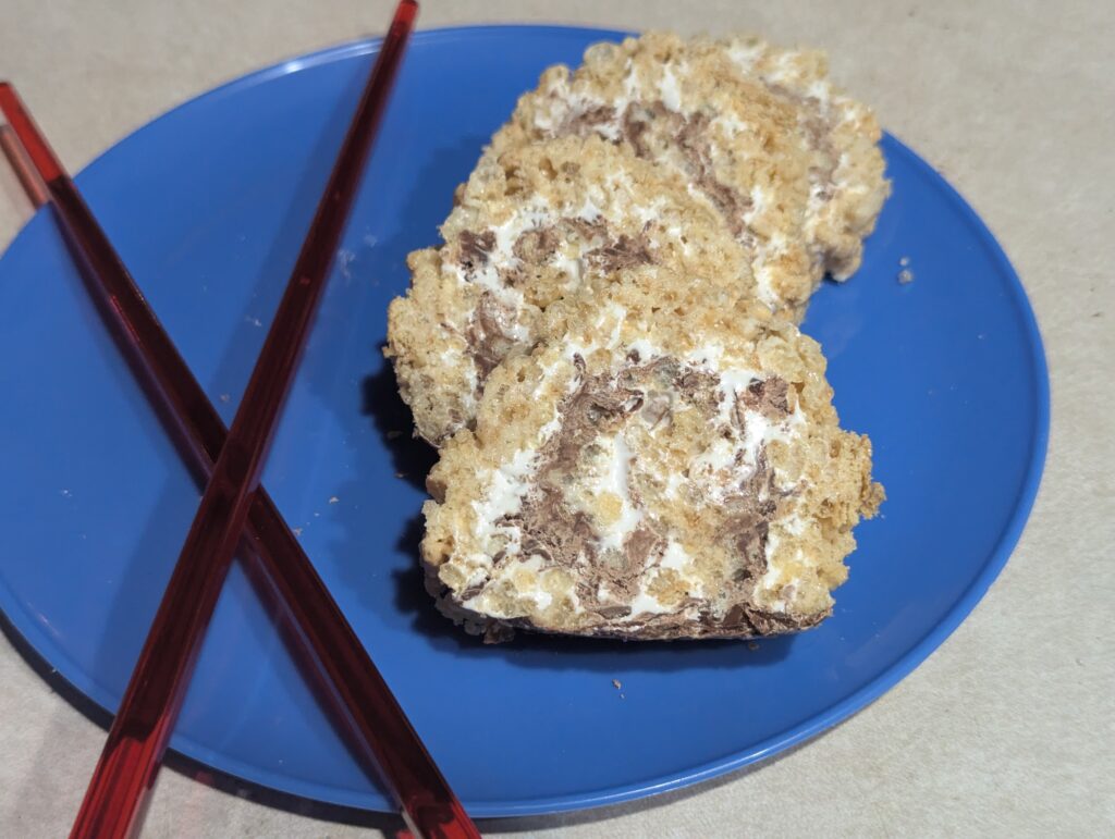 several slices of treat on a blue plate with chopsticks