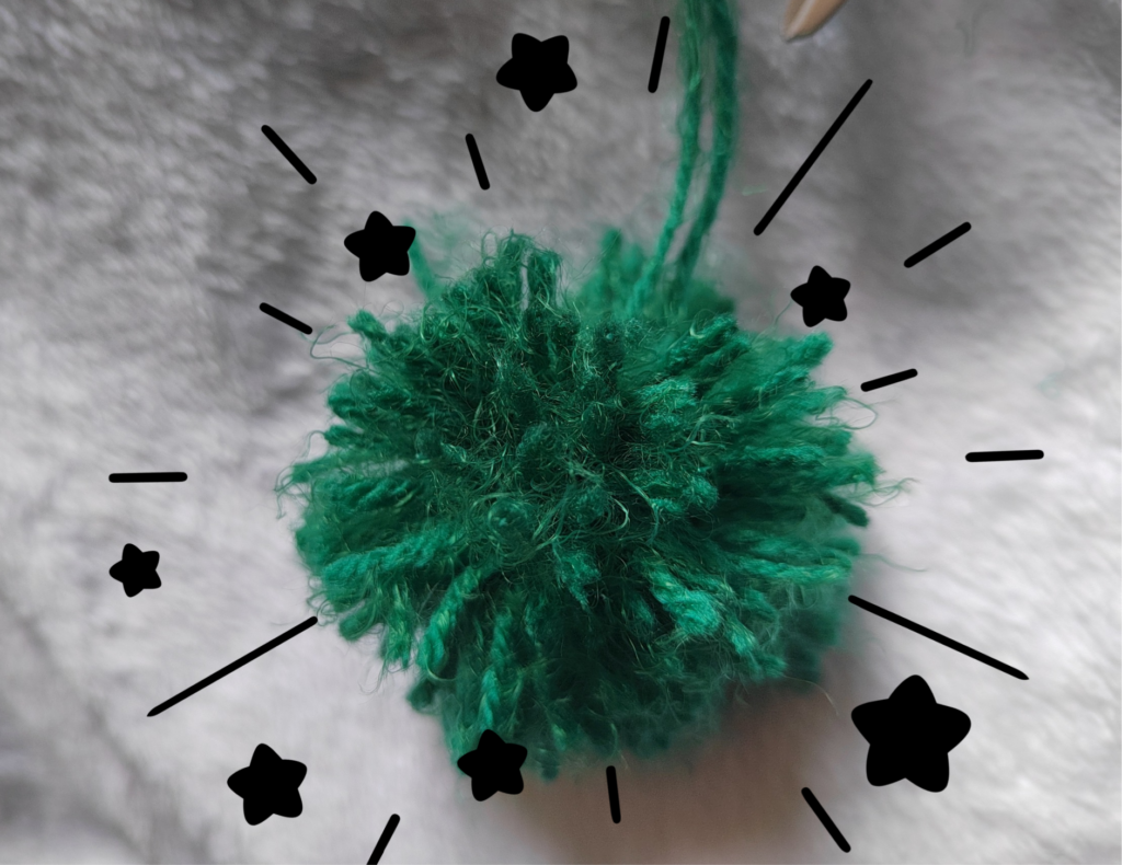 a green yarn pompom