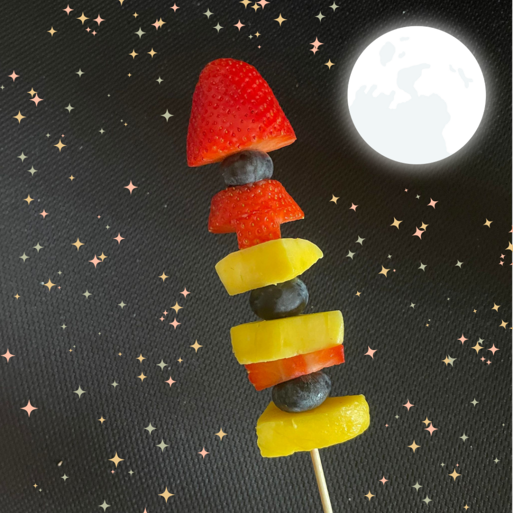 fruit placed on a wooden skewer to make a "rocket"