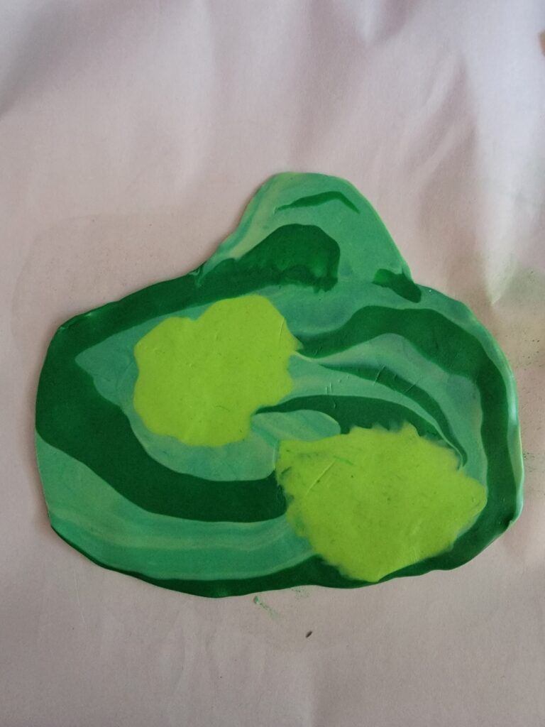 multi-color green clay mixed into a swirling patter and rolled flat
