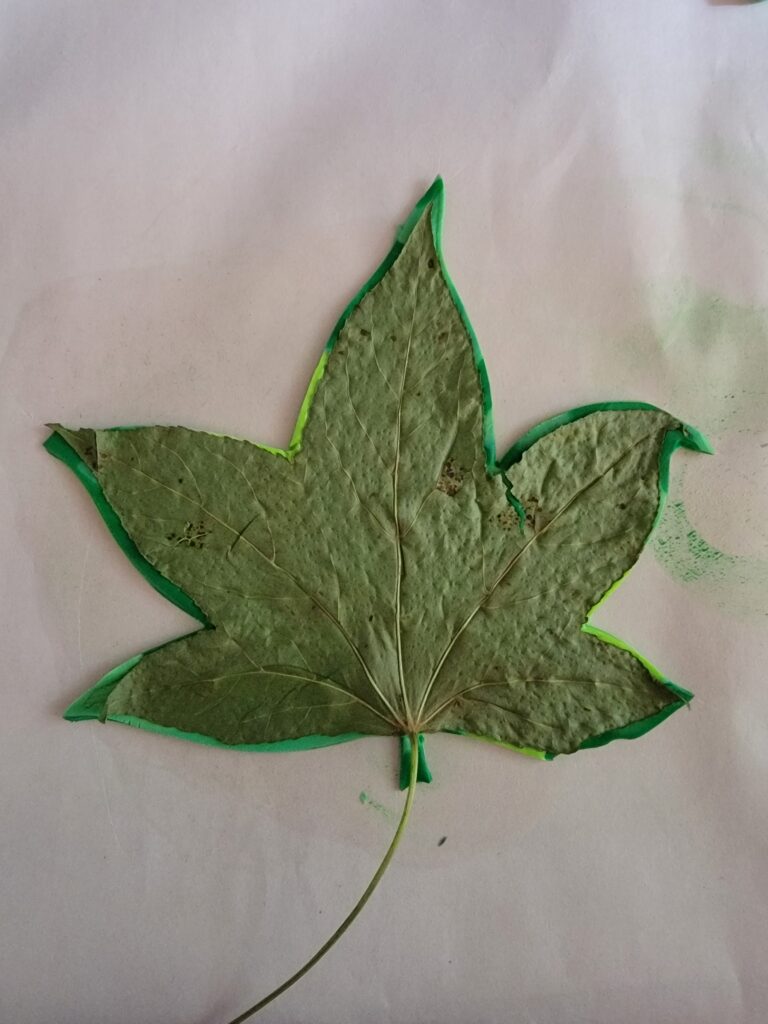 the excess clay around the leaf has been cut away to "trace" the leaf shape