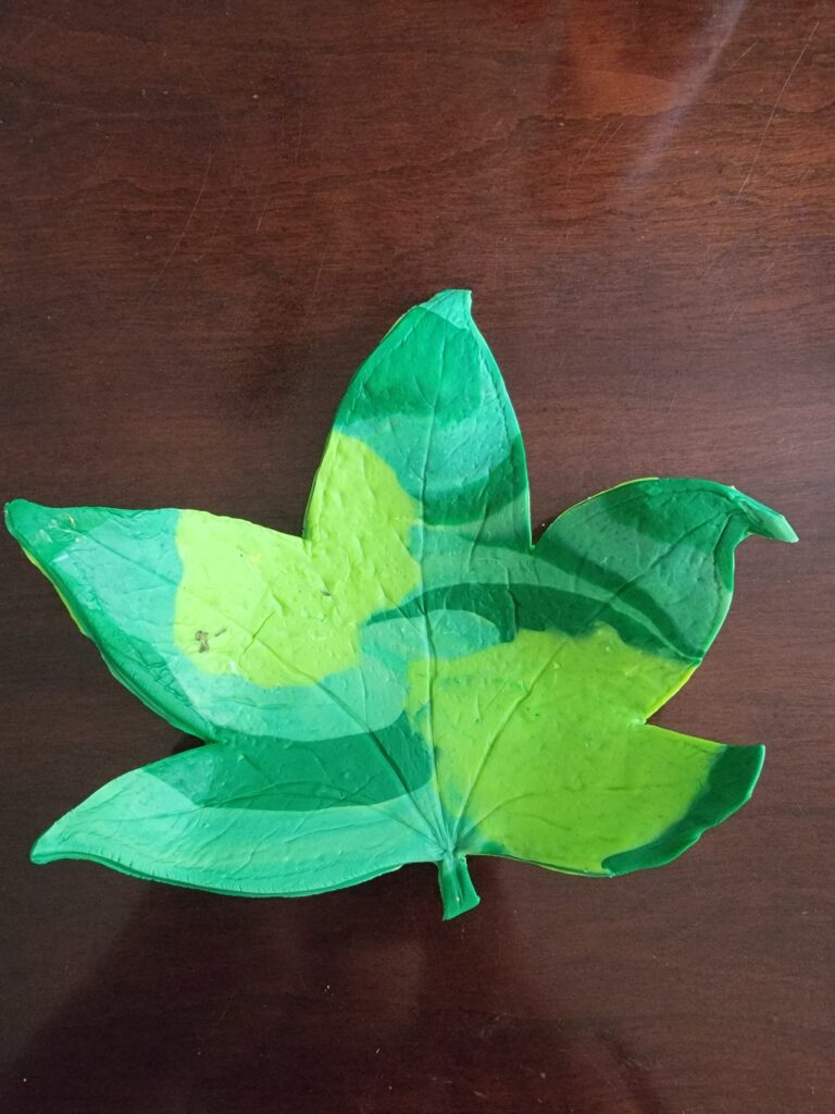 the clay has dried into a finished bowl that looks like a curling leaf