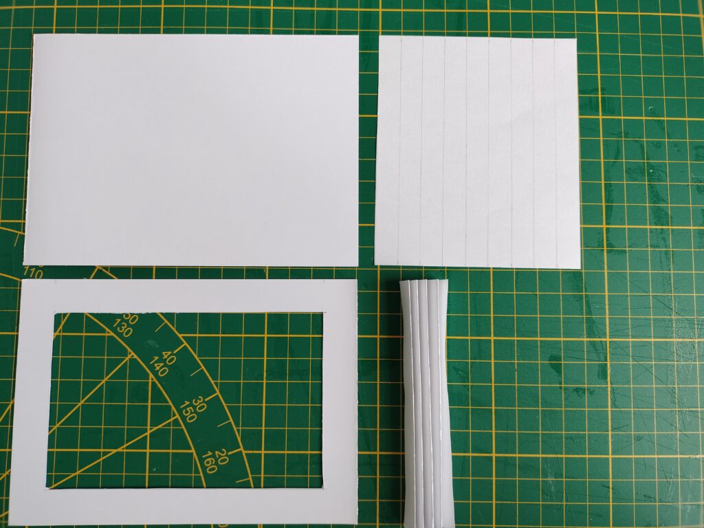 supplies for cabinet of curiosities including cutting board and paper