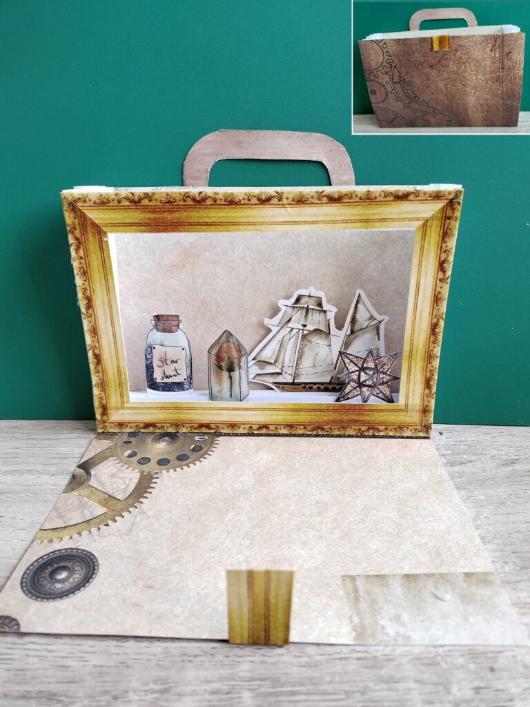 the completed paper cabinet has a gold-colored frame and all the items are inside