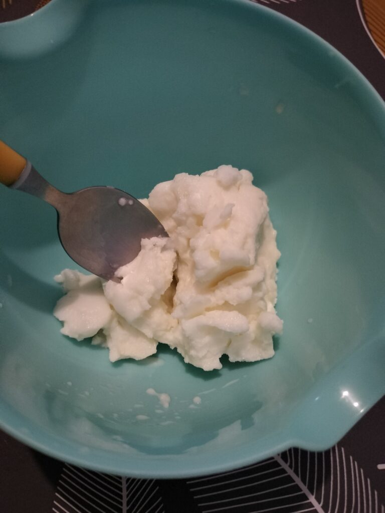 ice cream has been removed from small bag and placed into another small blue bowl; a spoon rests to the side, ready to scoop up a bite