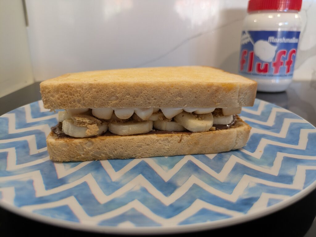 the two slices of bread with layered ingredients are now placed on top of one another in layers